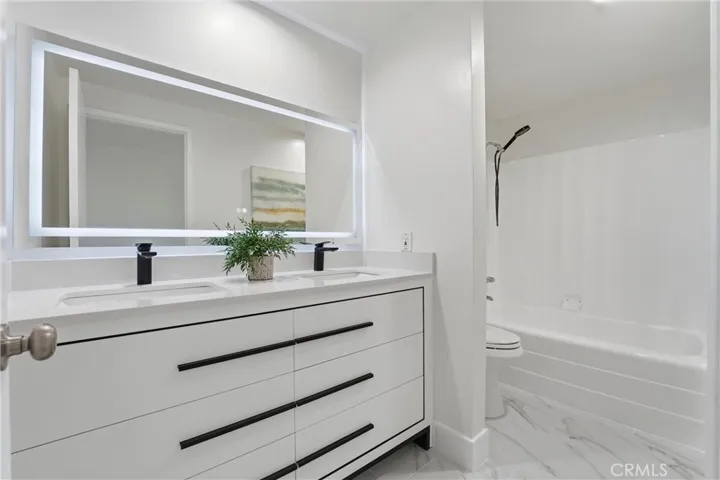 2nd Bathroom has double sink with brand new vanity, Brand new flooring and re-glazed tub.