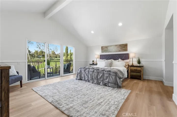 Primary bedroom with vaulted ceilings, recessed lights and balcony with the view of golf course.