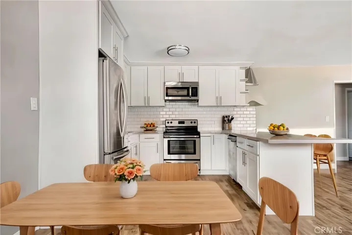 Dining and kitchen. (Virtually enhanced).