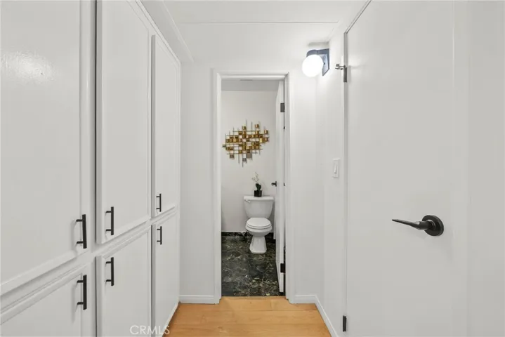 6 door of shelving on the left and utility closet on the right