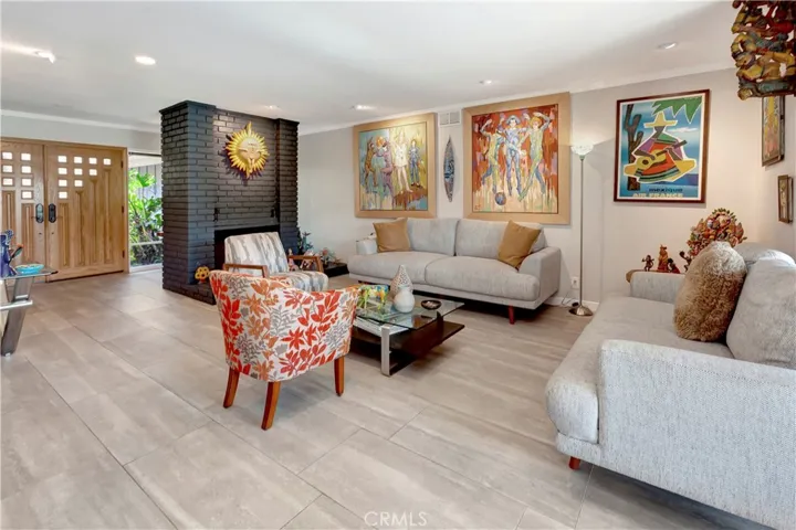 Sophisticated formal living room with oversized tile flooring and impressive double-door entry.l