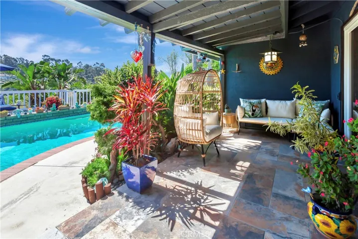 Lovely covered outdoor living niche great for entertaining or just relaxing.