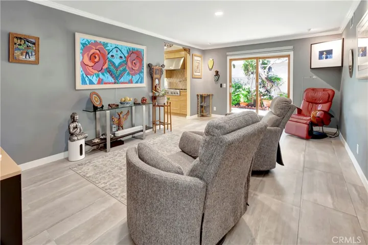 Family room with oversized tile flooring and access to side patio space.