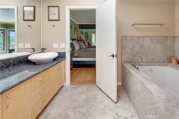 Primary bathroom previously remodeled with oversized soaking tub and separate shower stall.