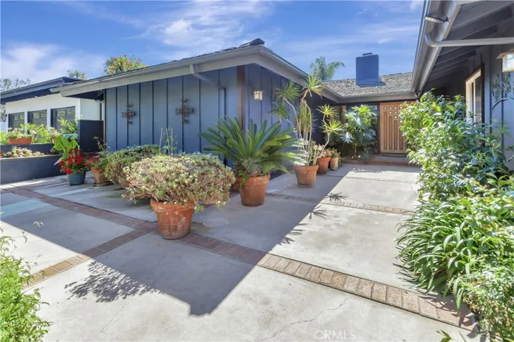 Large entryway is fenced-in and could be reimagined as a courtyard patio space.