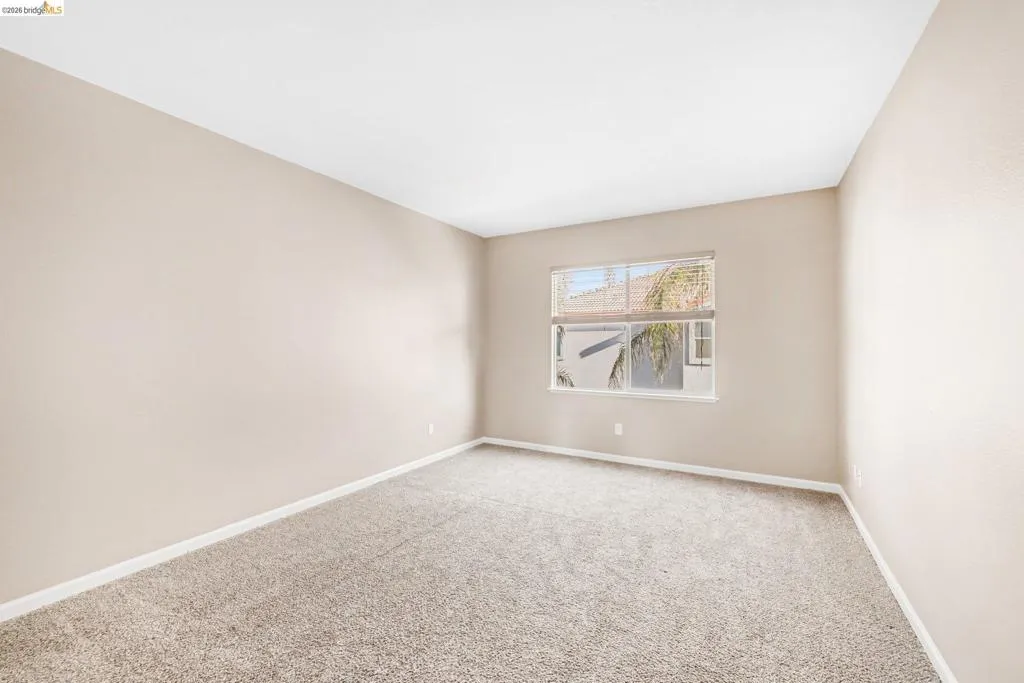 Carpeted spare room with baseboards