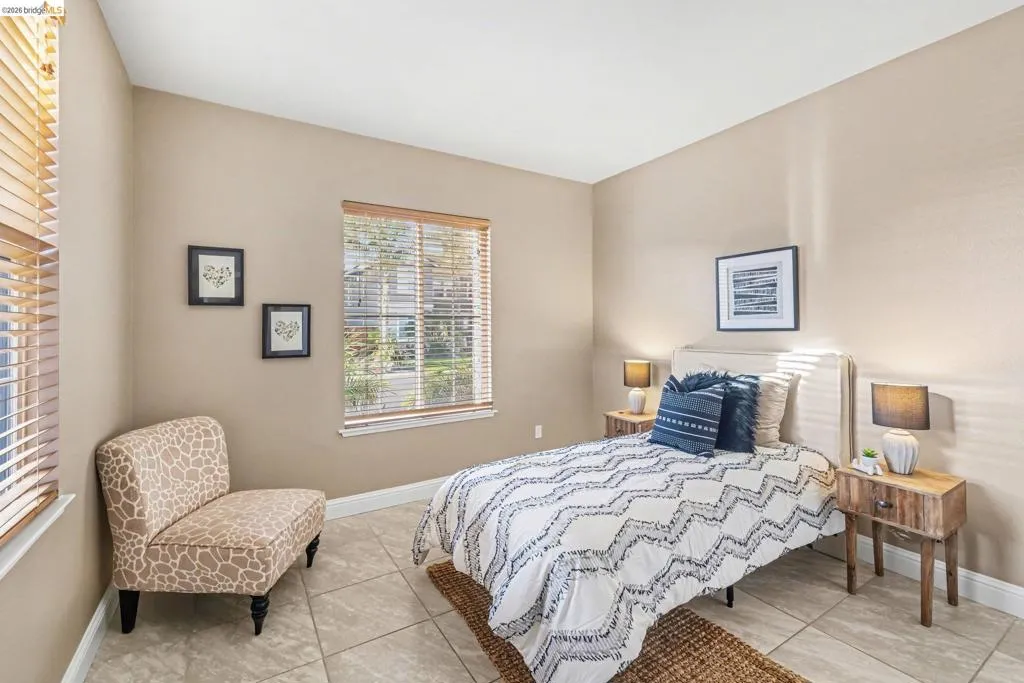 Bedroom featuring baseboards and light tile patterned floors