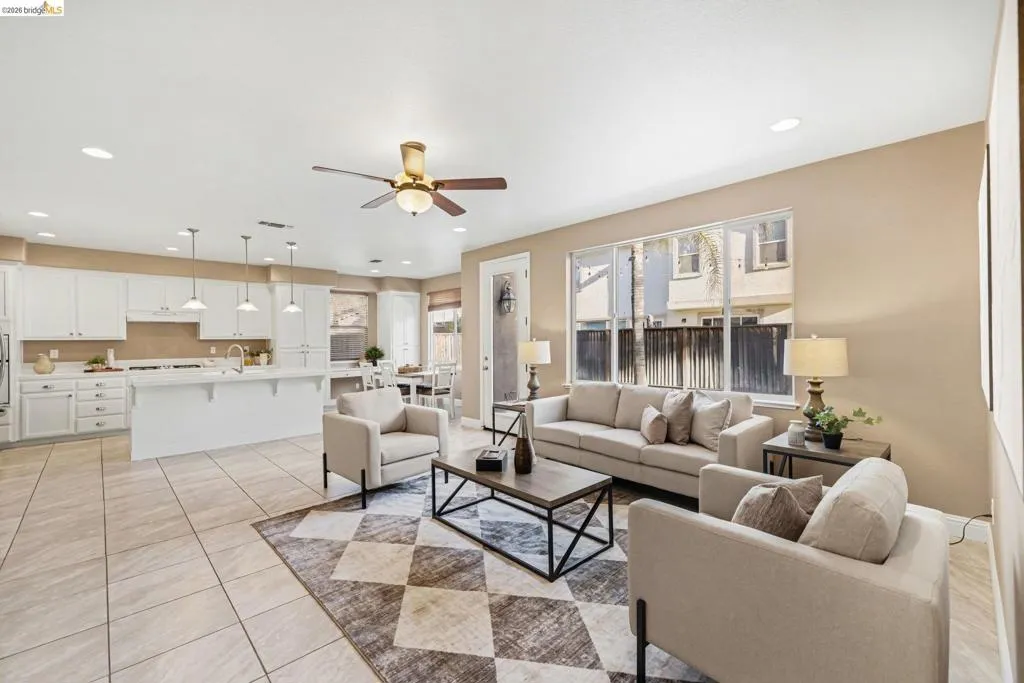 Living room featuring recessed lighting, a ceiling fan, and light tile patterned flooring