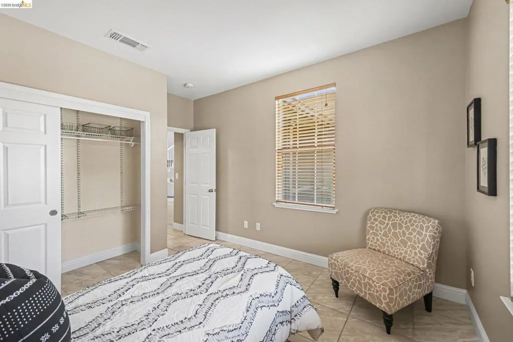 Bedroom featuring a closet and light tile patterned flooring
