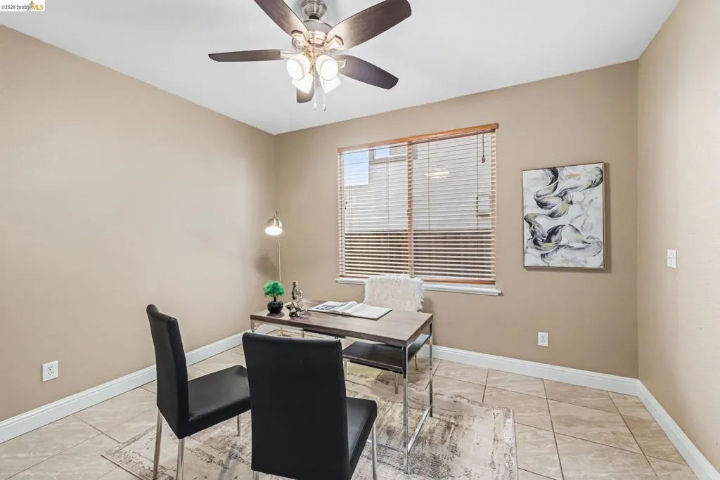 Office featuring ceiling fan and light tile patterned flooring