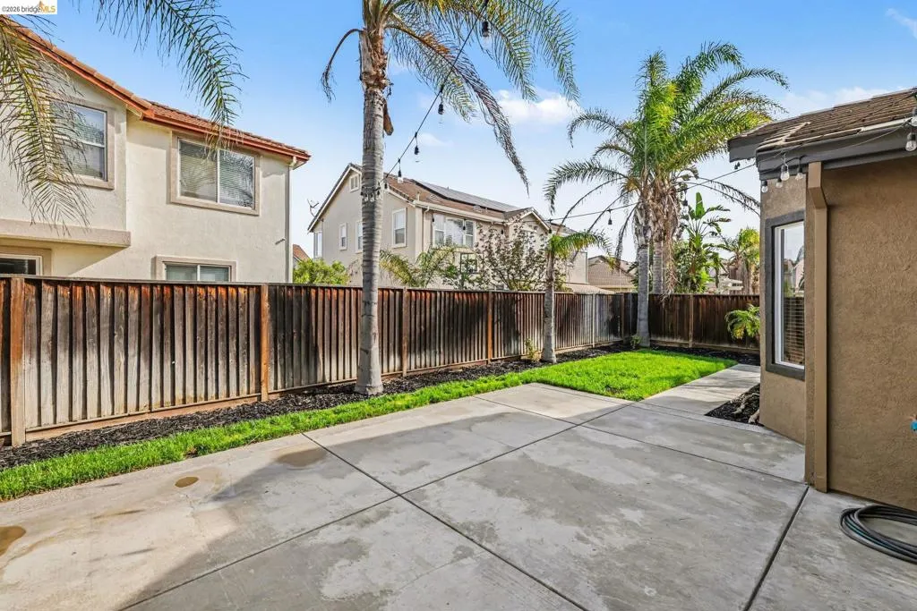 Fenced backyard with a patio