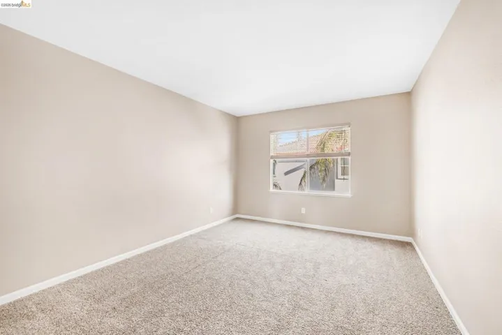 Carpeted spare room with baseboards