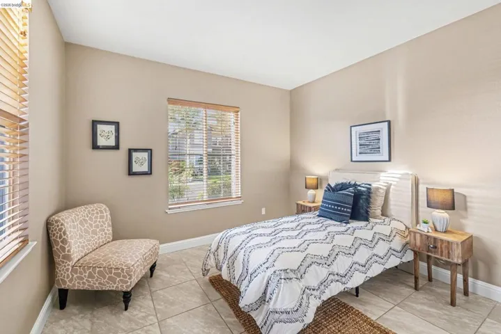 Bedroom featuring baseboards and light tile patterned floors