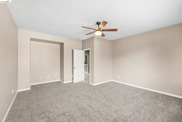 Unfurnished bedroom featuring carpet flooring and ceiling fan