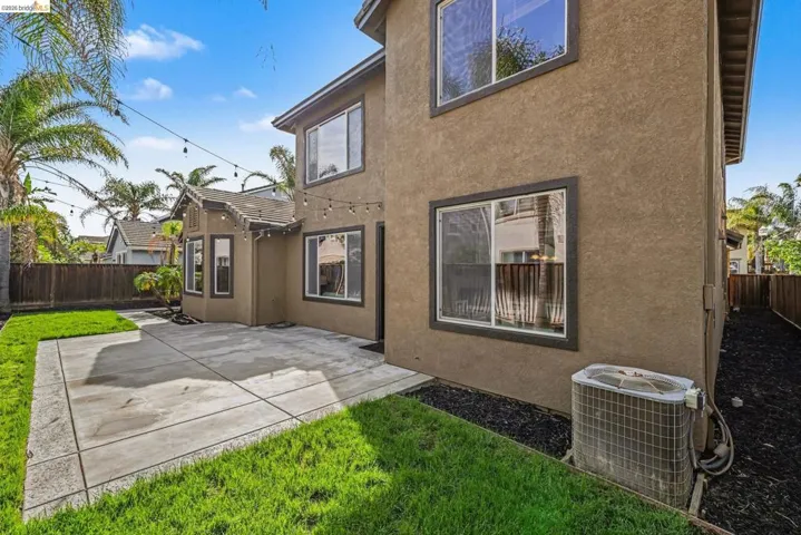 Back of house featuring a patio area, a fenced backyard, and stucco siding