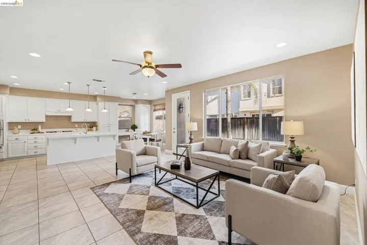 Living room featuring recessed lighting, a ceiling fan, and light tile patterned flooring