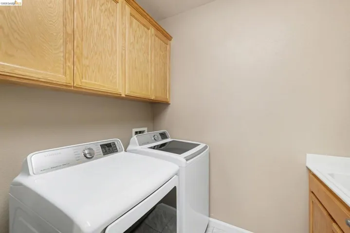 Laundry area featuring cabinet space and washing machine and dryer