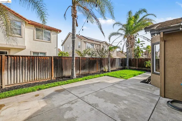 Fenced backyard with a patio