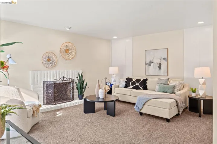 Carpeted living room featuring a brick fireplace and recessed lighting