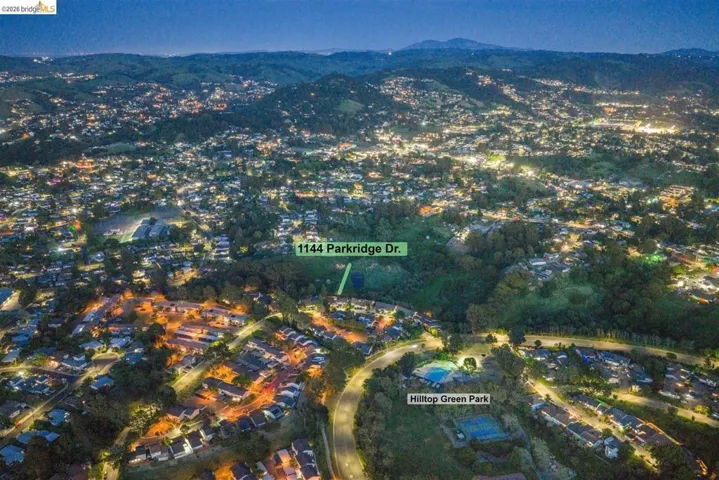 Aerial perspective of suburban area featuring a mountainous background