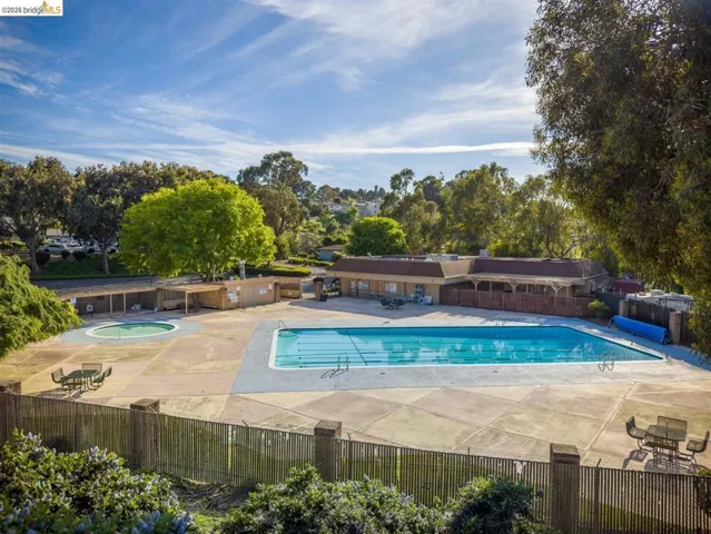 Community pool featuring a patio and a community hot tub