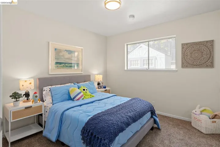 Bedroom featuring carpet floors and baseboards