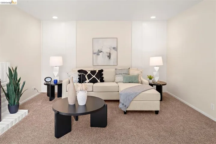 Carpeted living area with recessed lighting