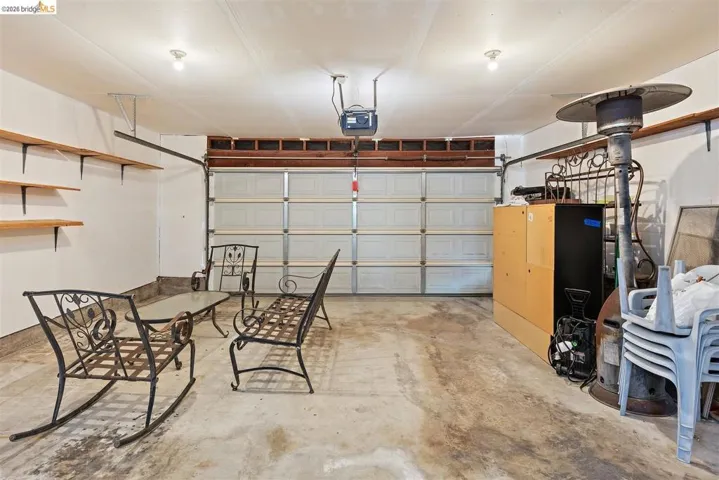 Garage featuring a garage door opener