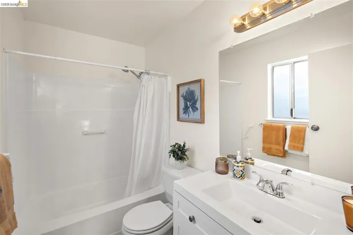 Full bath featuring vanity and shower / tub combo