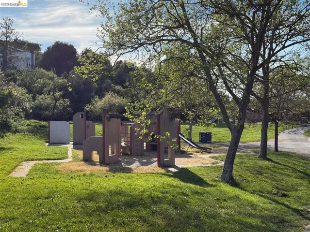 View of playground with a lawn