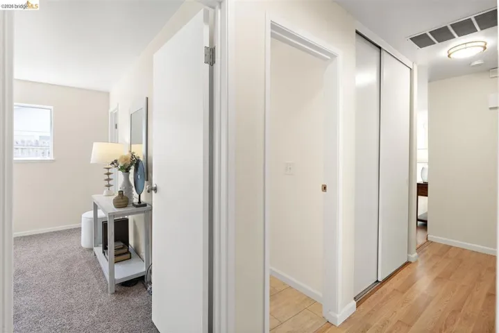 Corridor with baseboards and light wood-style floors