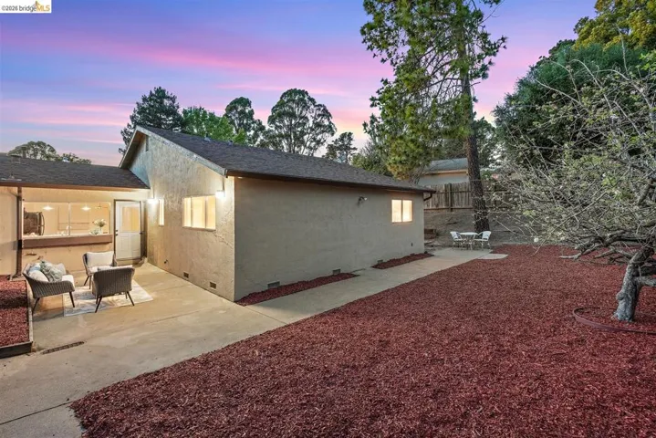 Back of property featuring crawl space, a patio, stucco siding, and roof with shingles