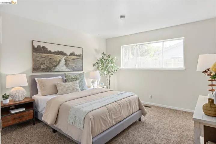 Carpeted bedroom with baseboards