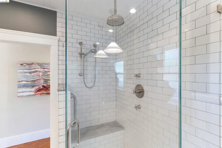Full bathroom featuring a stall shower and rain shower!