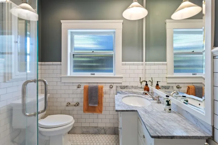Elegant period bathroom with marble tile and walk-in rain shower.