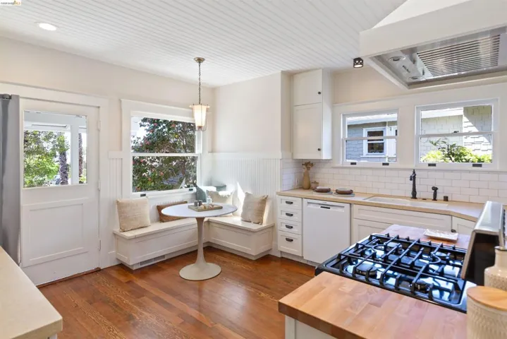 A cook's kitchen featuring breakfast area and classic updates opens out to the backyard.