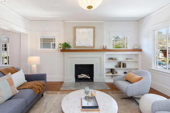 A wood burning fireplace with built in book shelves anchor this room.