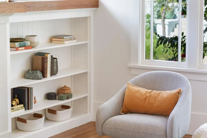 Living room featuring oak floors and built in book shelves.