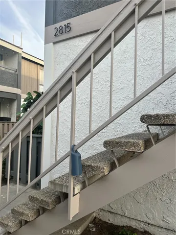 Lockbox is on stair rail left of front door.