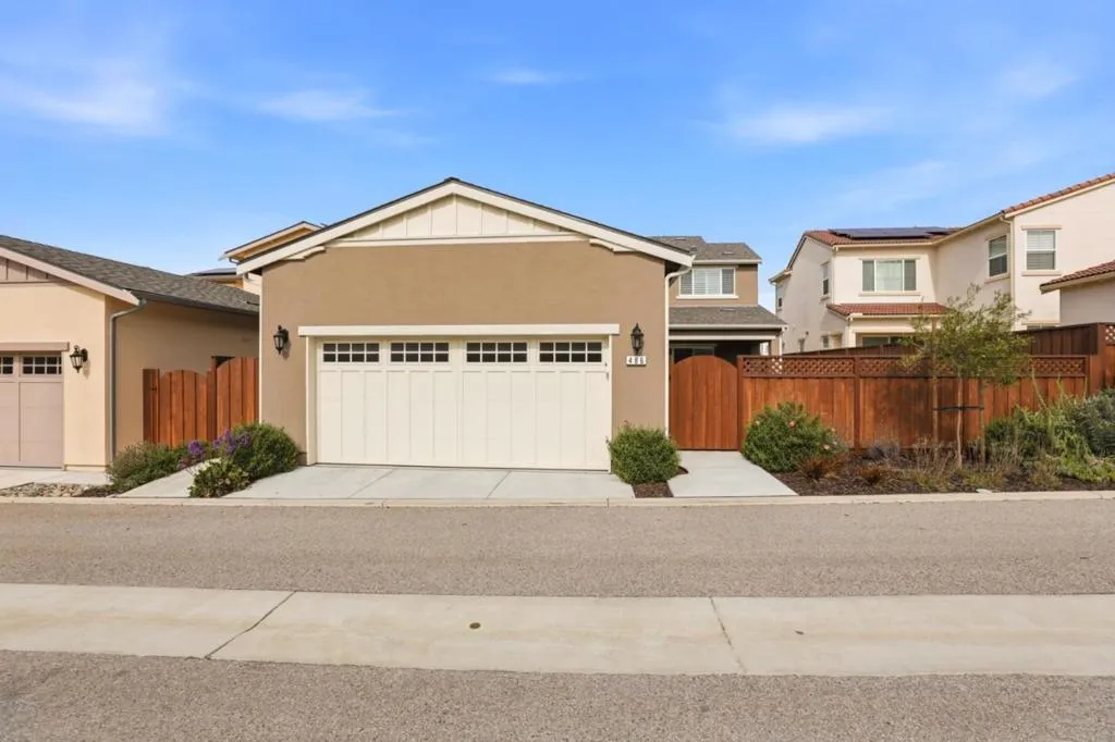 Attached garage with private alley access. Clean lines and low-maintenance landscaping.
