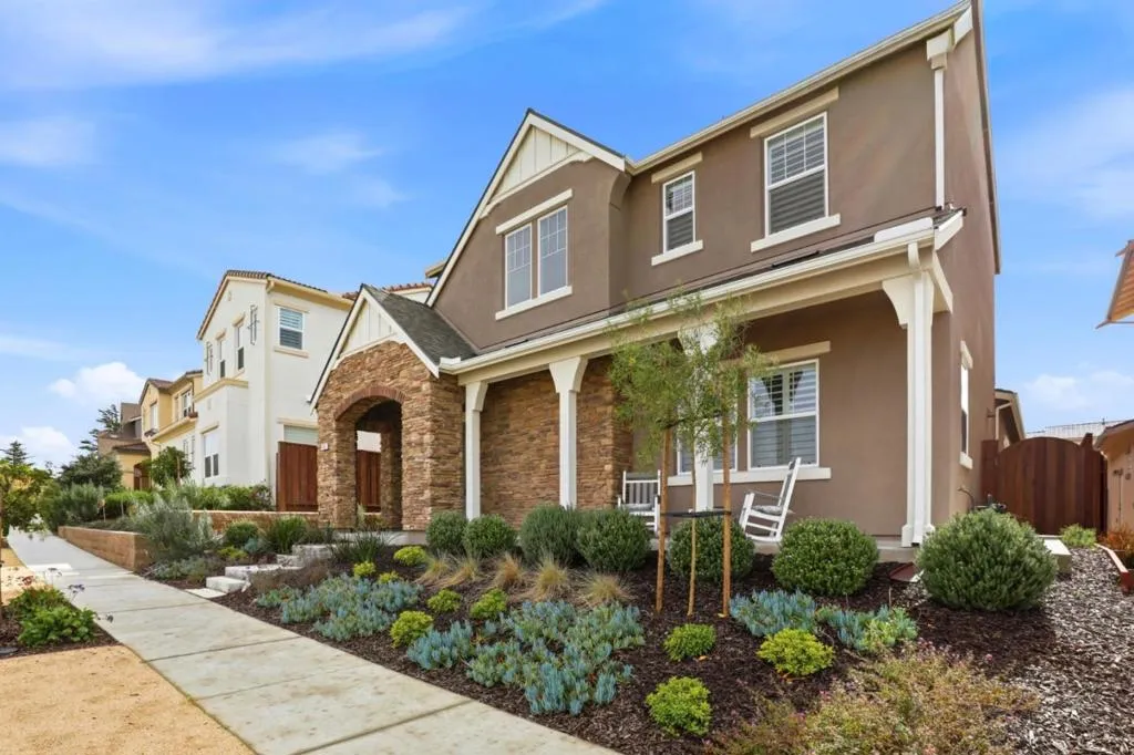 Striking curb appeal with timeless architecture, stone-accented façade, and beautifully landscaped.