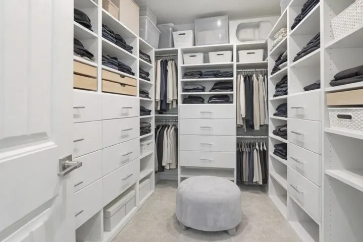 Primary Closet - Spacious custom walk-in closet featuring built-ins, and abundant storage.