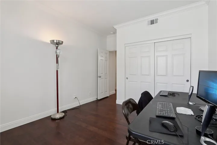 Versatile main floor bedroom or office with closet storage and a functional layout