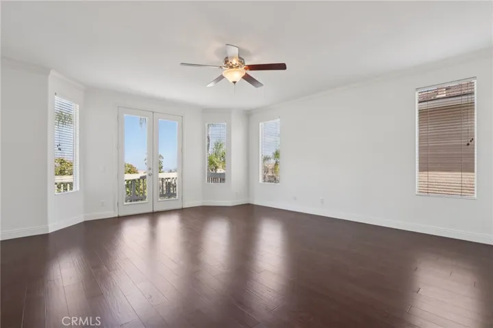 Spacious primary bedroom with private balcony access and plentiful natural light