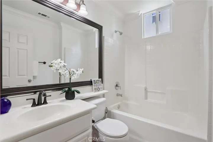 Main level bathroom with single-sink vanity and shower-tub combo