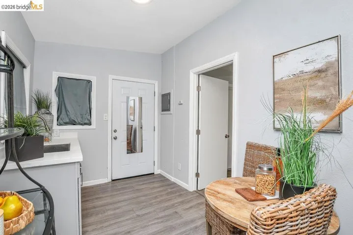 Foyer with light wood-type flooring and baseboards