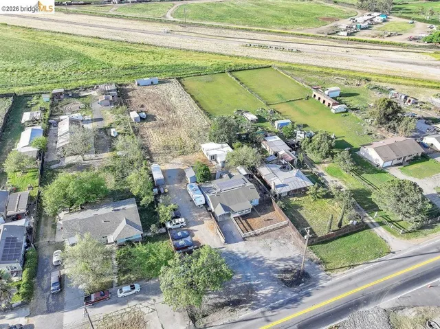Aerial view of sparsely populated area featuring rows of crops
