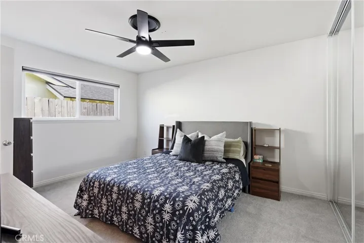 Primary bedroom with 8' high mirrored closet doors