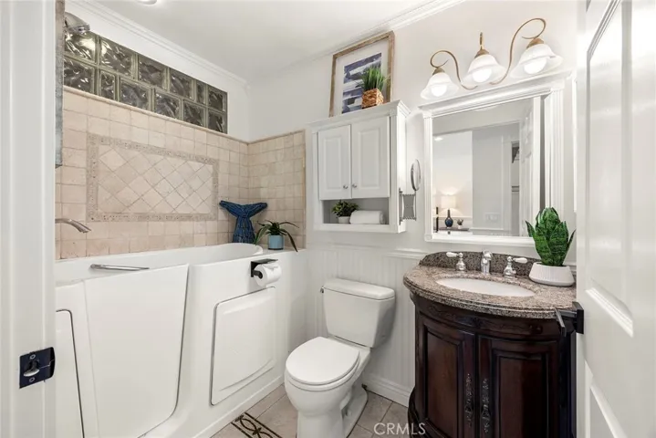 Primary bathroom featuring an updated vanity and modern fixtures, with accessible features thoughtfully installed by the previous owners that can be easily modified or removed to suit your preferences.
