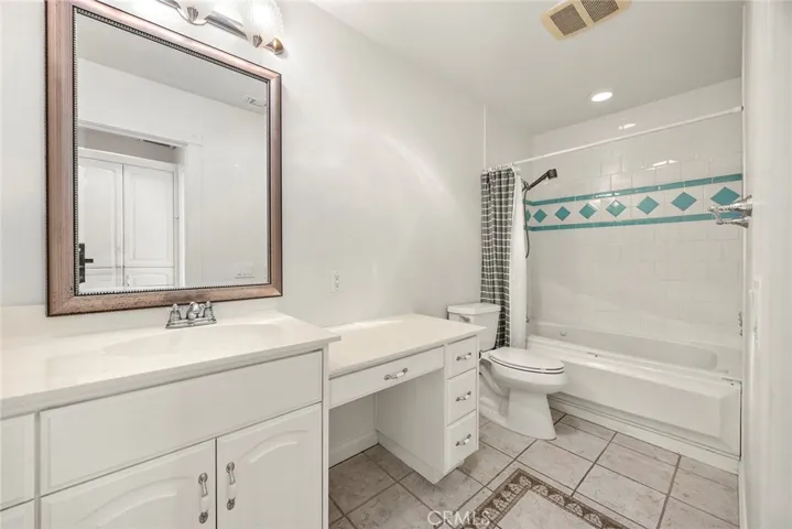 Upstairs full bath featuring a clean, bright design with a functional layout, a sweet vanity area, a jetted tub, and ready for your personal touch.
